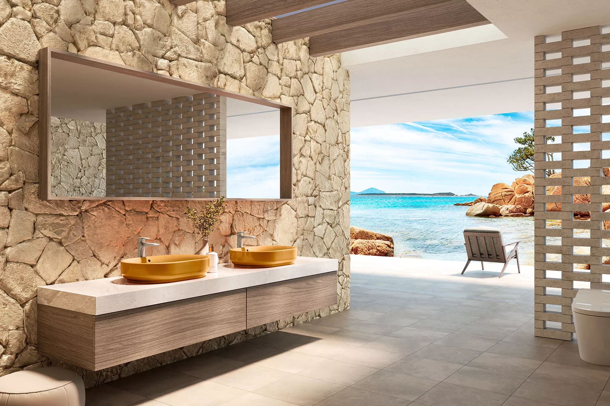 A coastal-inspired bathroom features two orange vessel lavatories set against a stone wall, opening to an ocean view.