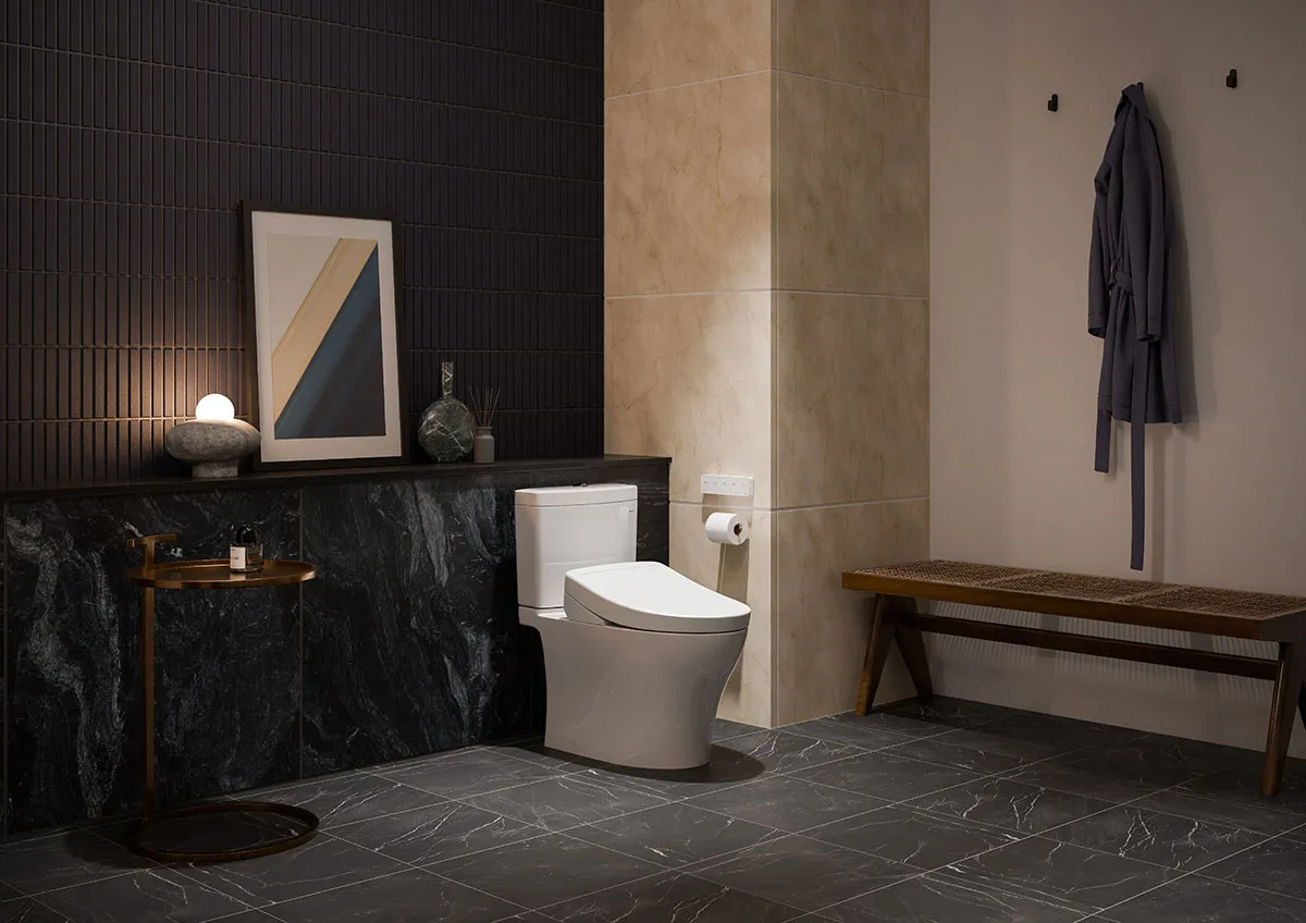 A WASHLET+ S5 bidet toilet is displayed in a modern, masculine bathroom with warm lighting and dark marble floor tile.