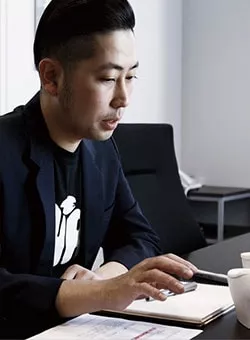 Photo of TOTO worker at a conference room table.