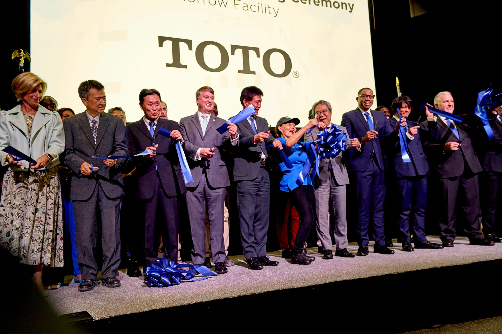 TOTO employees and dignitaries cut a ribbon at the Morrow production facility opening.