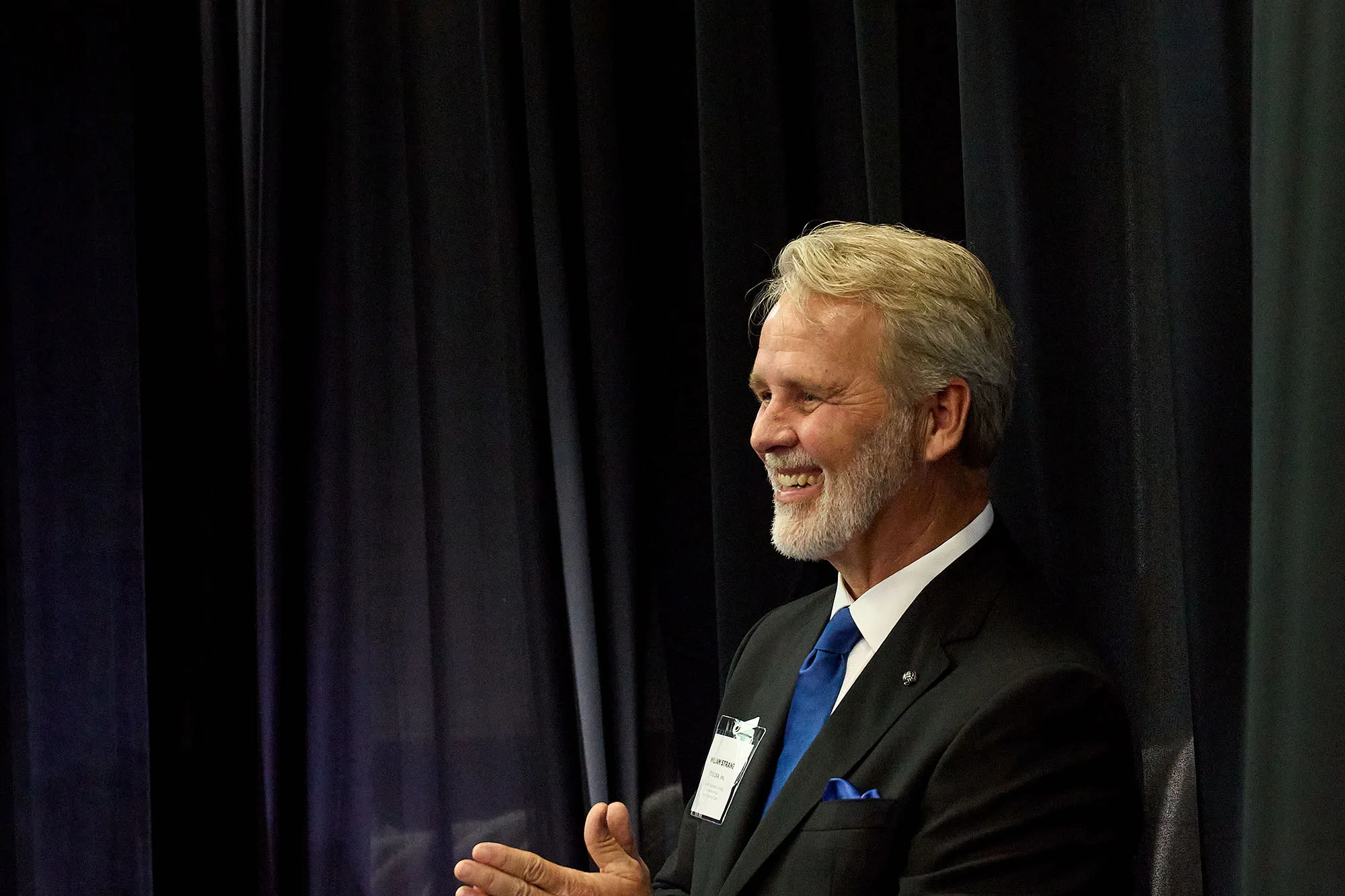 Bill Strang, TOTO USA’s President of Corporate Strategy, smiling and applauding during the Morrow facility ribbon-cutting.