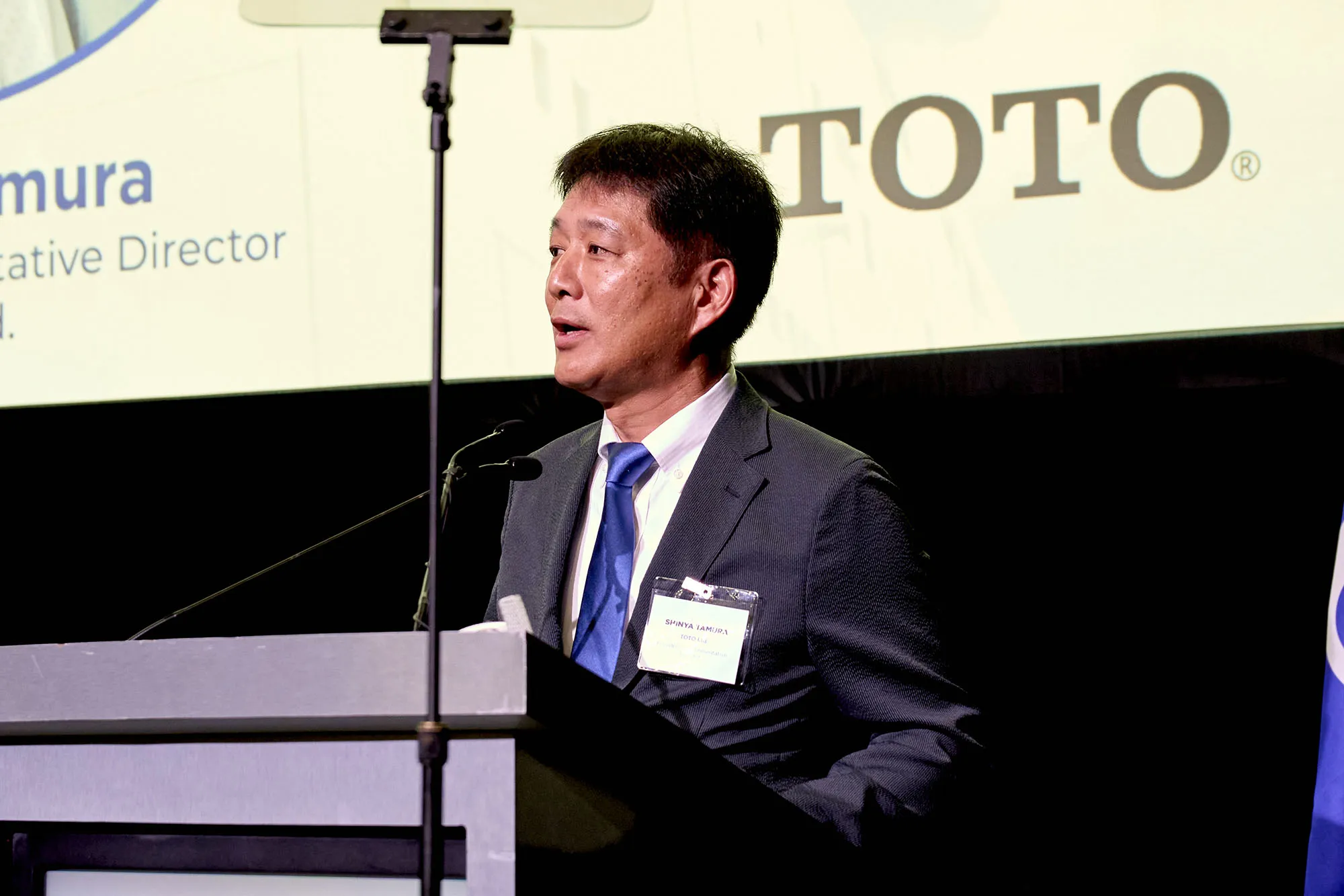 Shinya Tamura, President and Representative Director of TOTO Ltd., speaking at the Morrow facility ribbon-cutting ceremony.